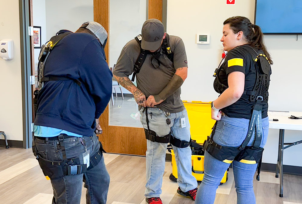 exosuit-workers-being-trained-insturction-exoskeleton-warehouse