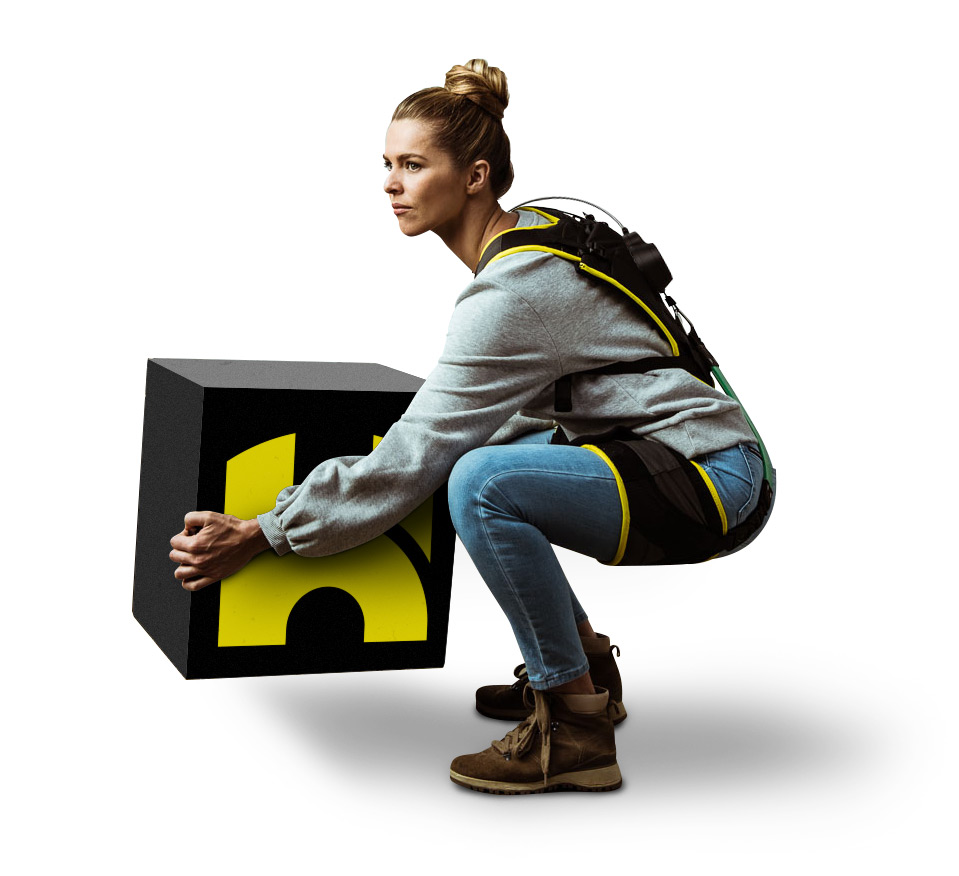 Woman model squatting while lifting box with HeroWear logo wearing HeroWear Apex exosuit.
